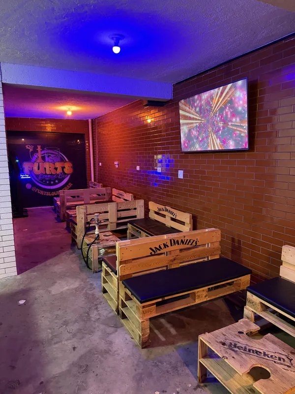 Bancos e mesas do lounge da Furts Lounge Bar em Curitiba